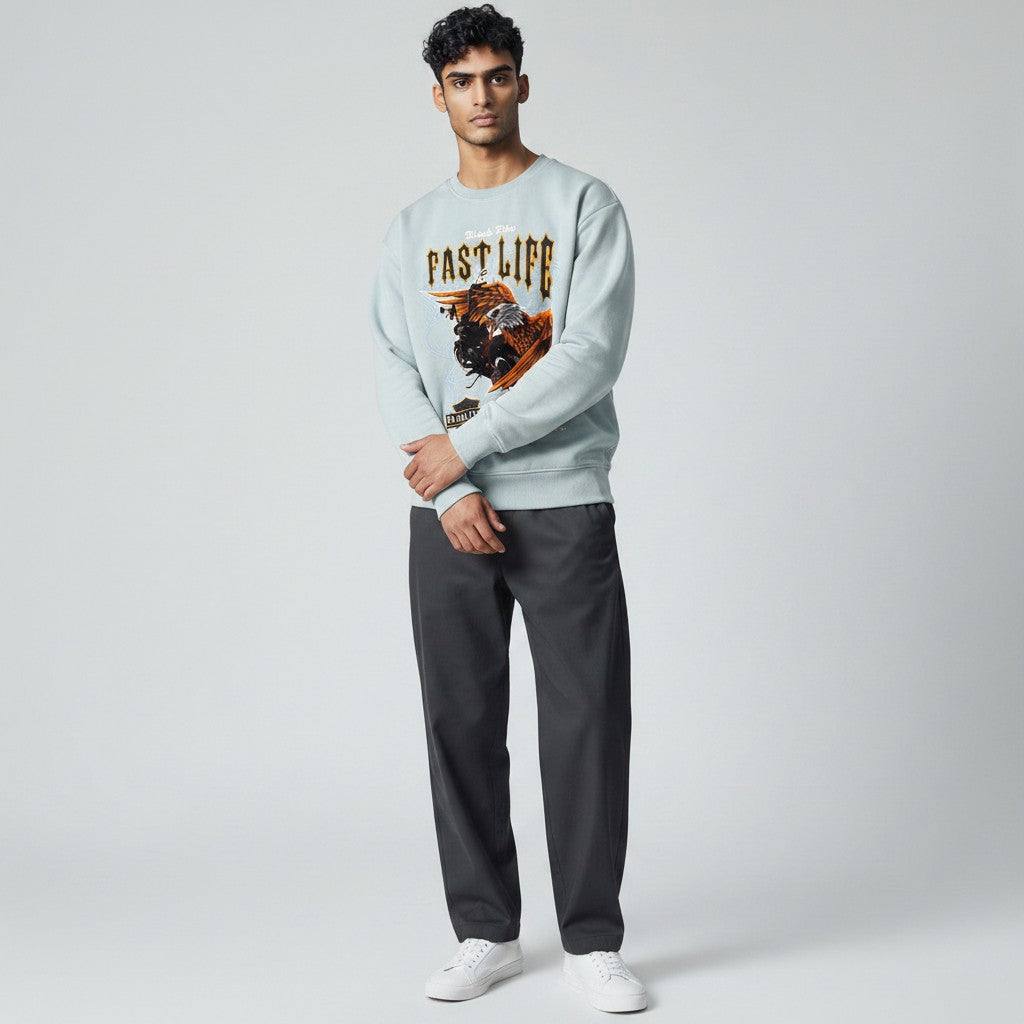 Looking Good Pine Bluff light blue sweatshirt with Fast Life graphic print worn by a male model with dark trousers.